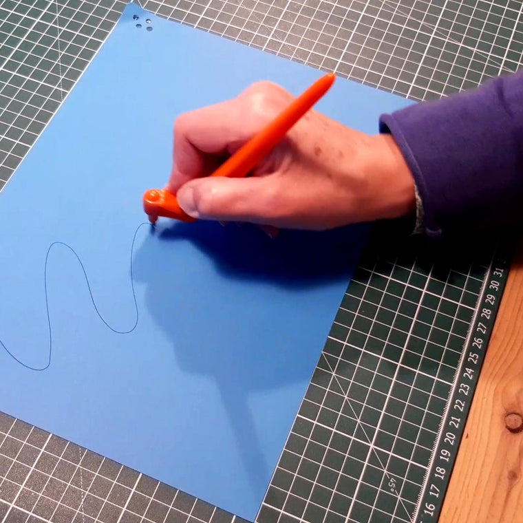 Drawing a curved shape in pencil before cutting